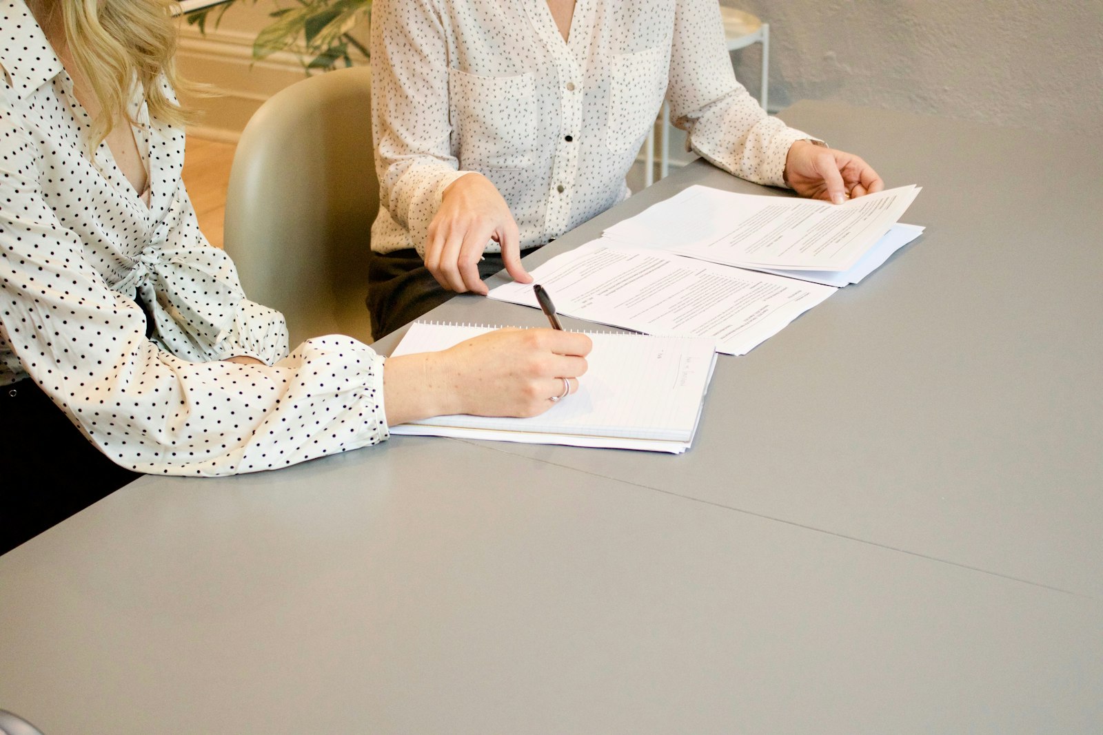 Two people signing documents