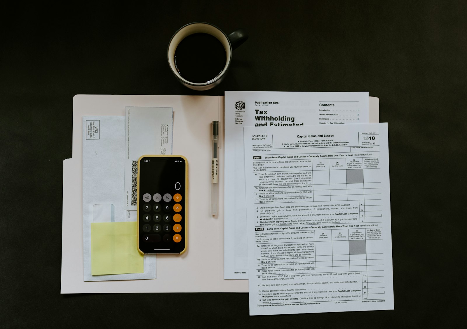 Tax forms and a calculator on a desk
